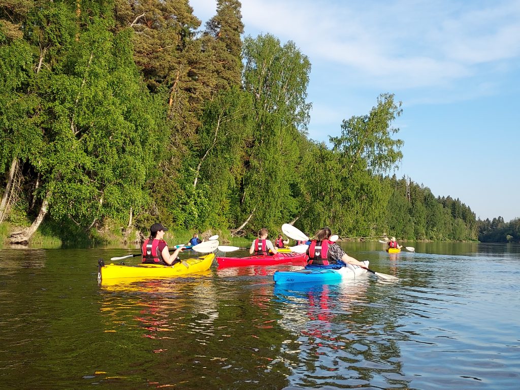 Avec Marjan melontaretki joella, jossa useita värikkäitä kanotteeja.