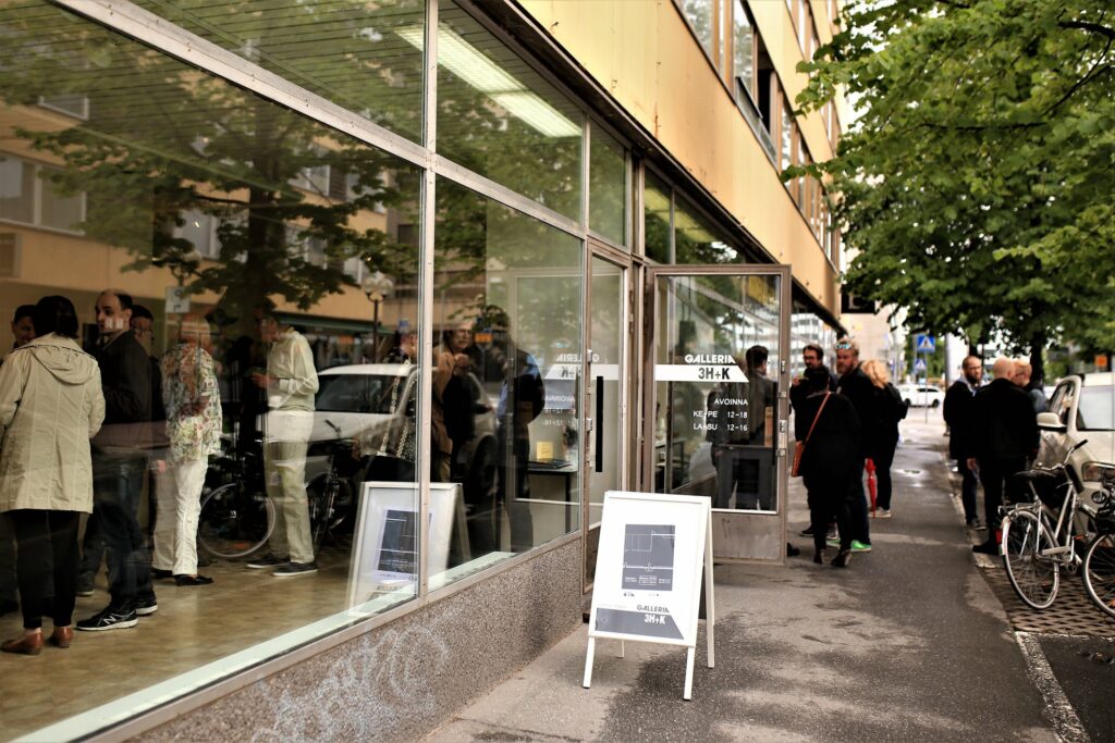 Gallery pictured from the street with people visiting the gallery