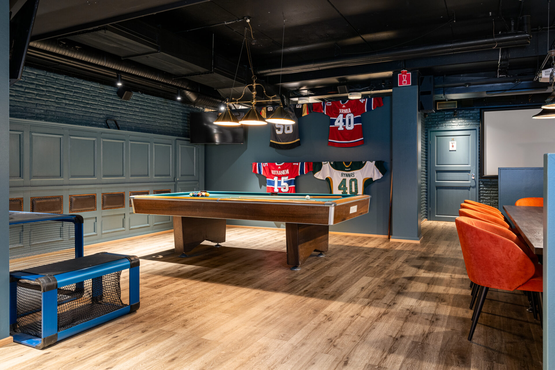 Renovated Winston inside with pool table and hockey jerseys on the wall.