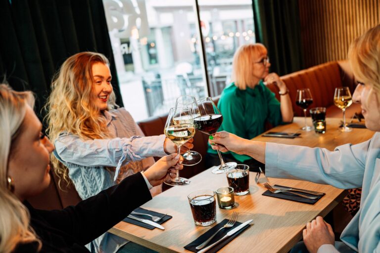 Women raise a glass at Kalevi Bar & Kitchen.