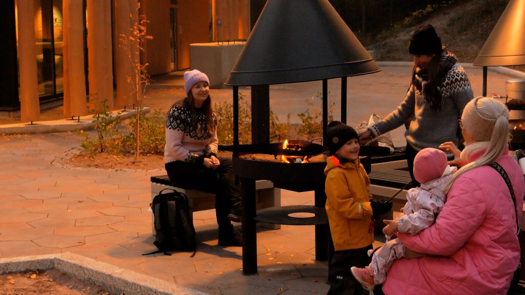 Ihmisiä grillaamassa Yyterin vierailukeskuksen pihan grillipaikalla