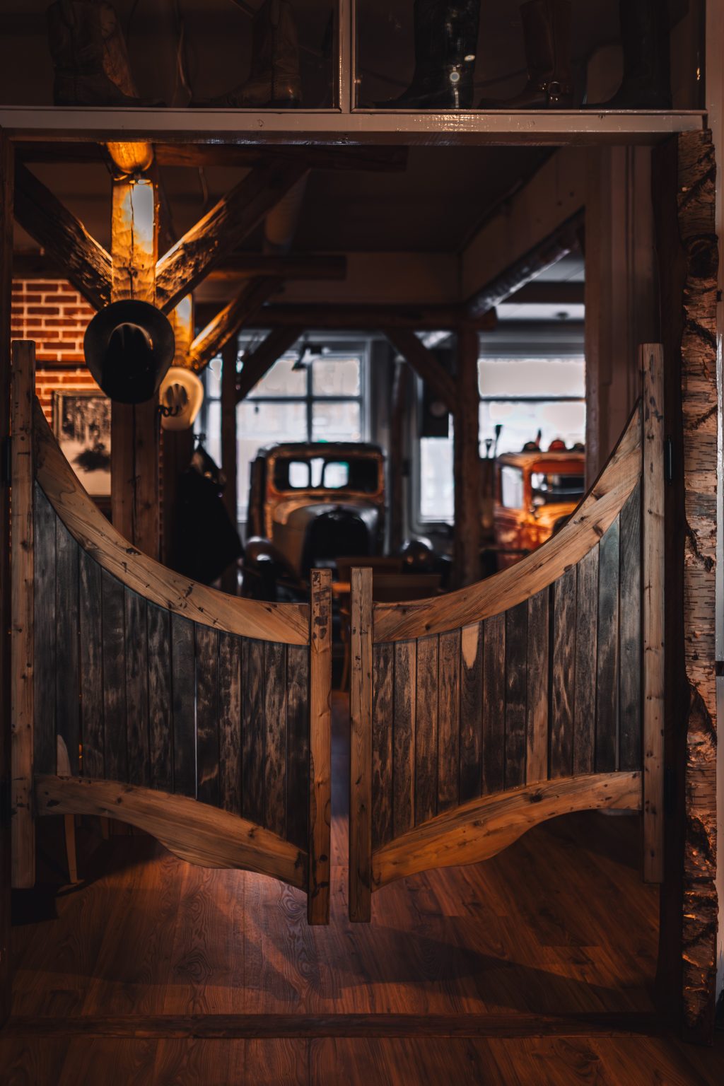 Cowboys Grill & BBQ ravintolan saluunan ovet edessä ja vanhoja autoja taustalla.